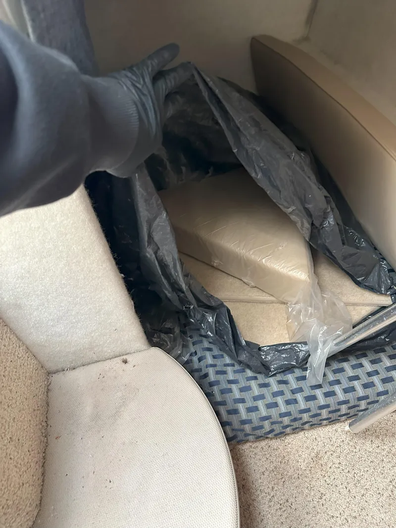 Slide: The Image of Interior of a 2005 Bayliner 245 CIERA with hidden compartment and packaged items. - 15