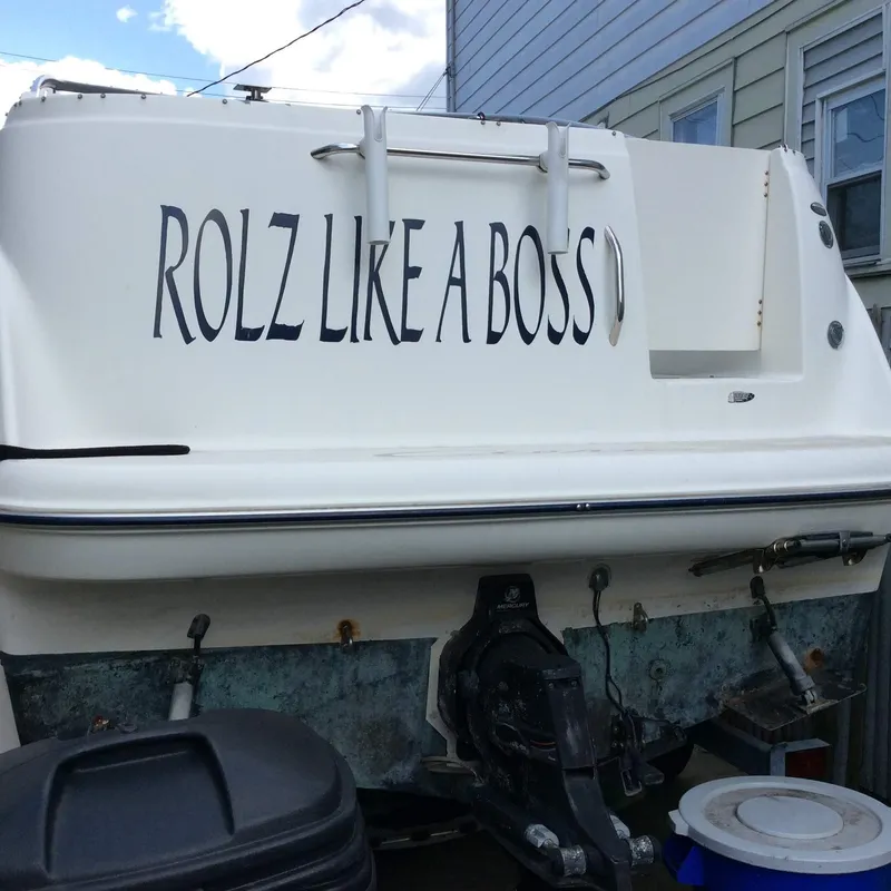 Slide: The Image of 2005 Bayliner 245 CIERA boat with "ROLZ LIKE A BOSS" text on the stern. - 16