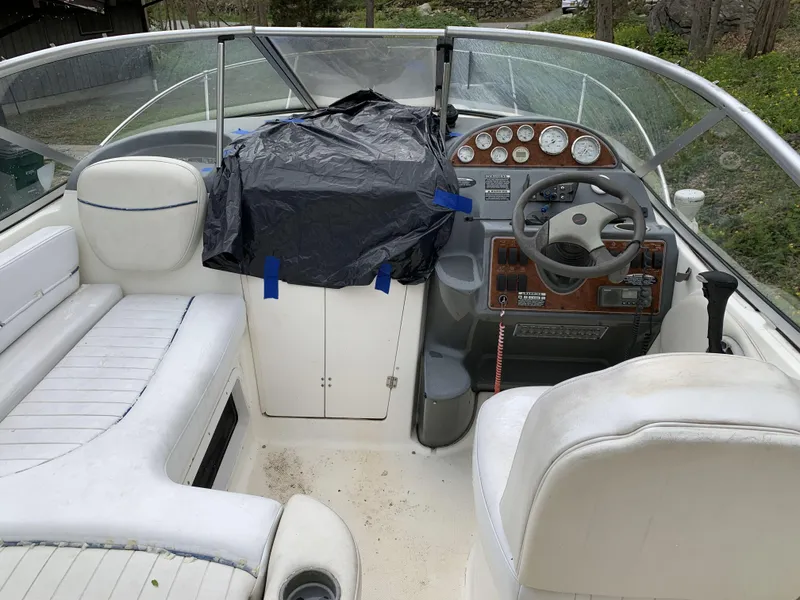 Slide: The Image of 2005 Bayliner 245 CIERA boat interior with steering wheel and seating area. - 4