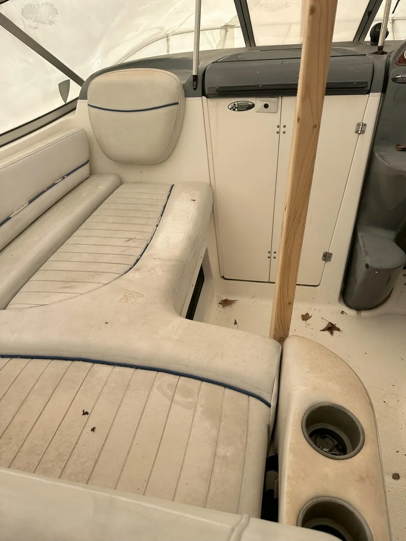 Slide: The Image of 2005 Bayliner 245 CIERA interior with beige seating and dashboard. - 5