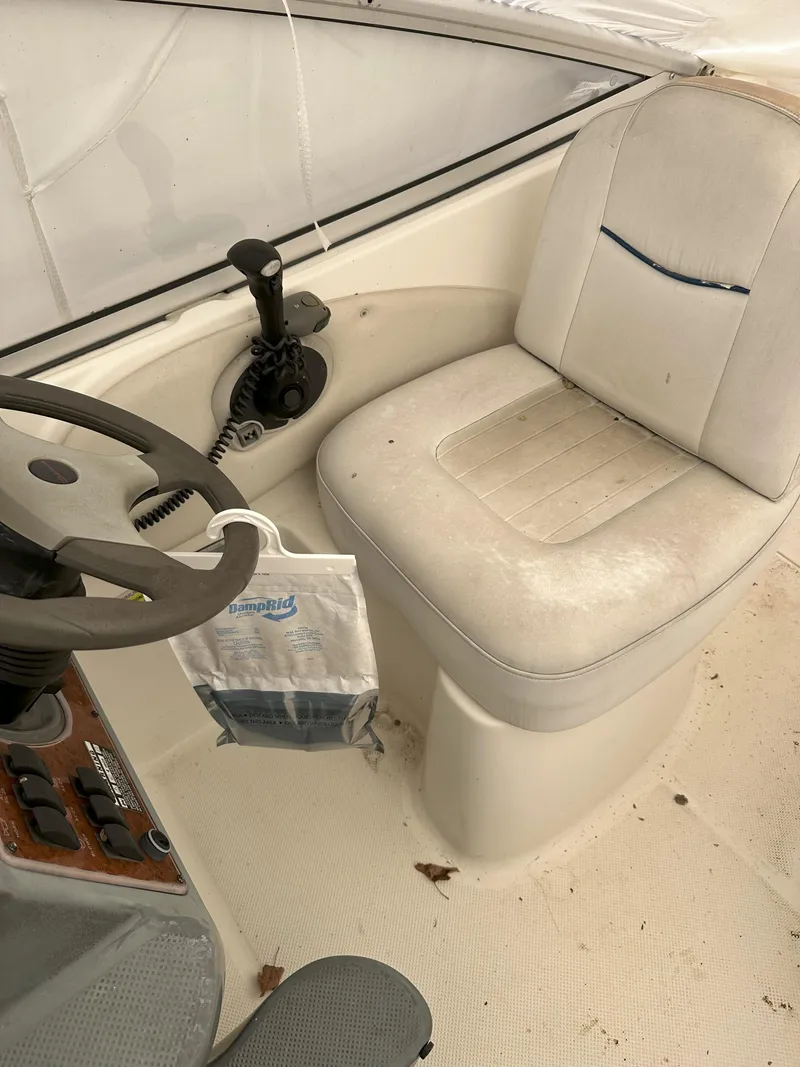 Slide: The Image of 2005 Bayliner 245 CIERA boat interior with steering wheel and captain's seat. - 7