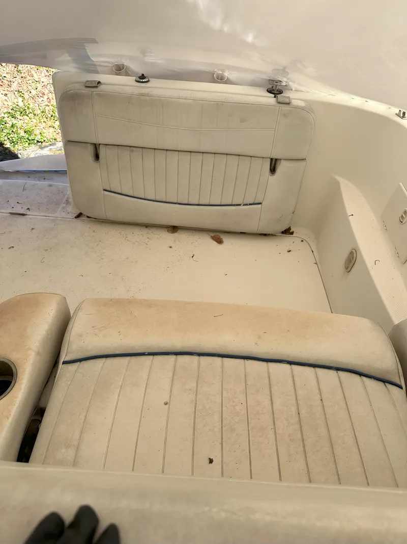 Slide: The Image of 2005 Bayliner 245 CIERA boat interior with white cushioned seating. - 8