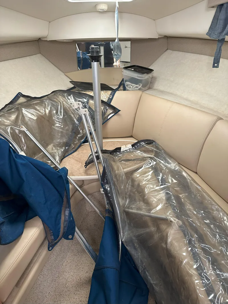 Slide: The Image of Interior of 2005 Bayliner 245 CIERA with beige seating and clear covers. - 9