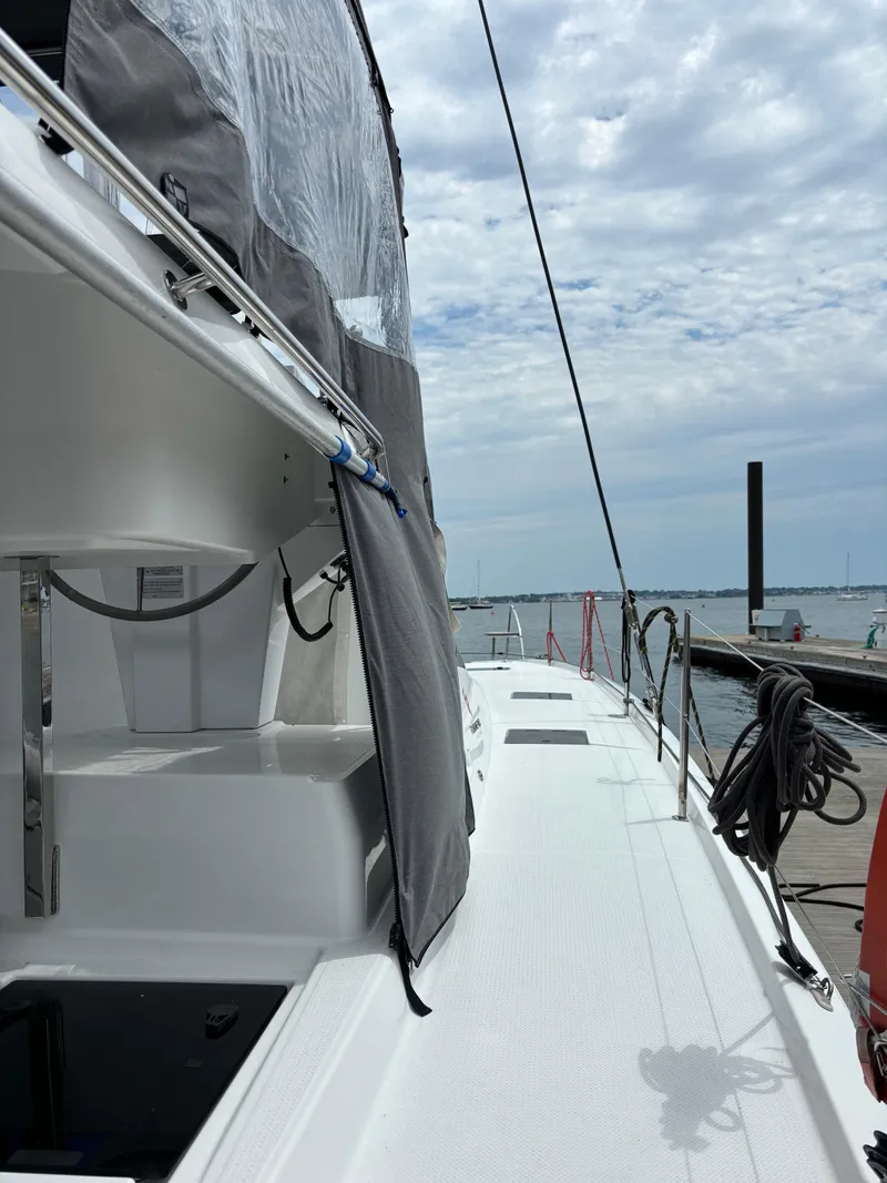 Slide: The Image of 2022 Fountaine Pajot Astrea 42 catamaran docked, showcasing sleek deck and sail details. - 14