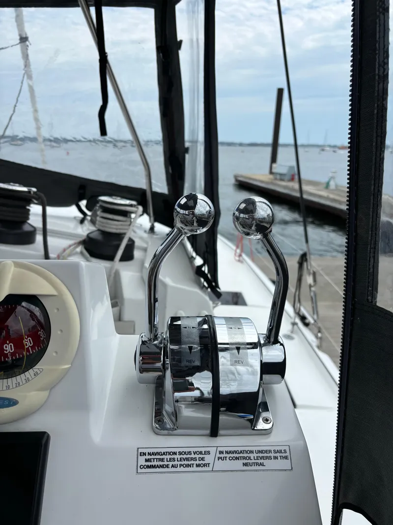 Slide: The Image of Cockpit controls of a 2022 Fountaine Pajot Astrea 42 catamaran, docked at a marina. - 17