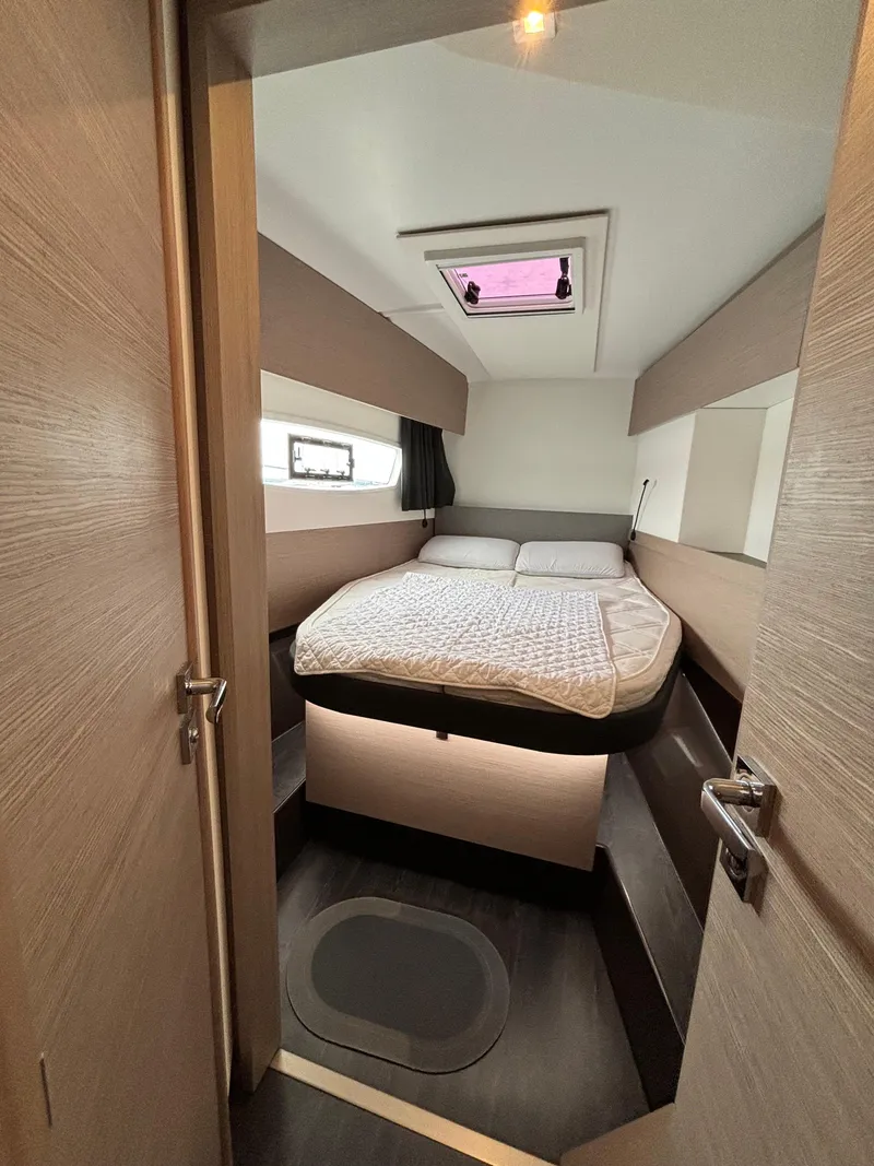 Slide: The Image of 2022 Fountaine Pajot Astrea 42 cabin interior with bed, modern design, and skylight. - 29