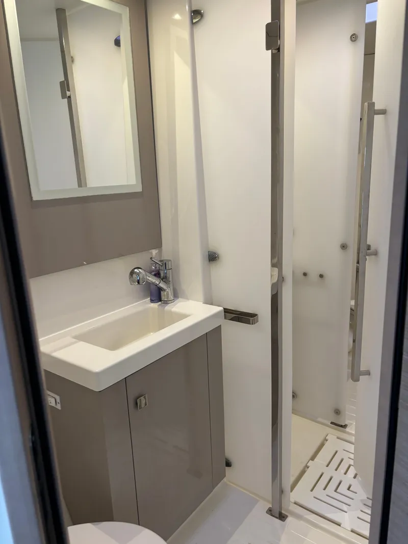 Slide: The Image of Modern bathroom in 2022 Fountaine Pajot Astrea 42 yacht, featuring sleek sink and shower. - 32
