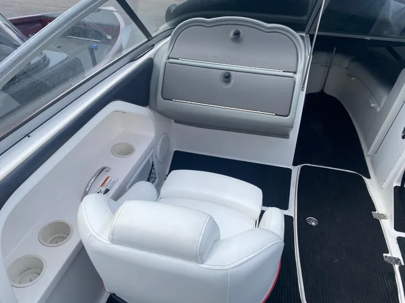Slide: The Image of 2006 Yamaha Boats SX230 HO interior with white seating and storage compartments. - 10