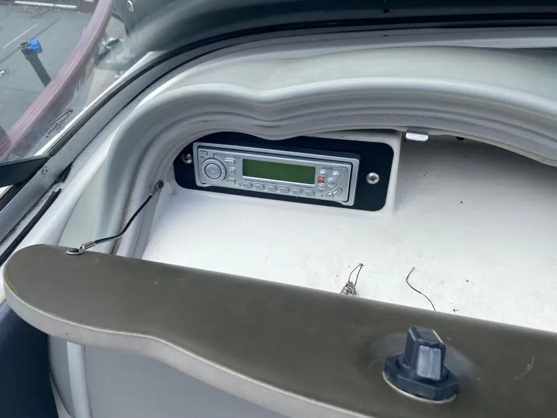 Slide: The Image of 2006 Yamaha Boats SX230 HO dashboard with built-in stereo system. - 11