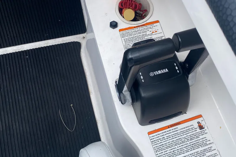 Slide: The Image of Yamaha SX230 HO 2006 boat throttle controls with safety instructions and accessories. - 14