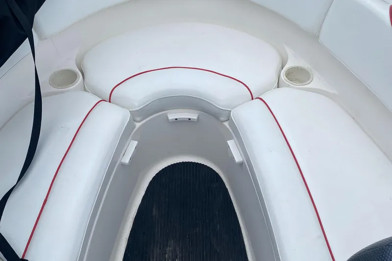 Slide: The Image of 2006 Yamaha Boats SX230 HO interior seating with white cushions and red trim. - 16