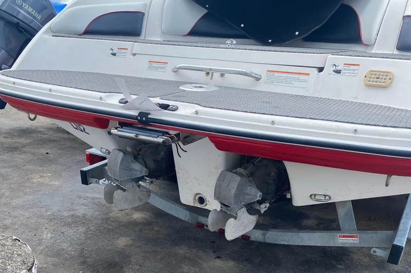 Slide: The Image of 2006 Yamaha Boats SX230 HO rear view, showcasing dual engines and trailer. - 2