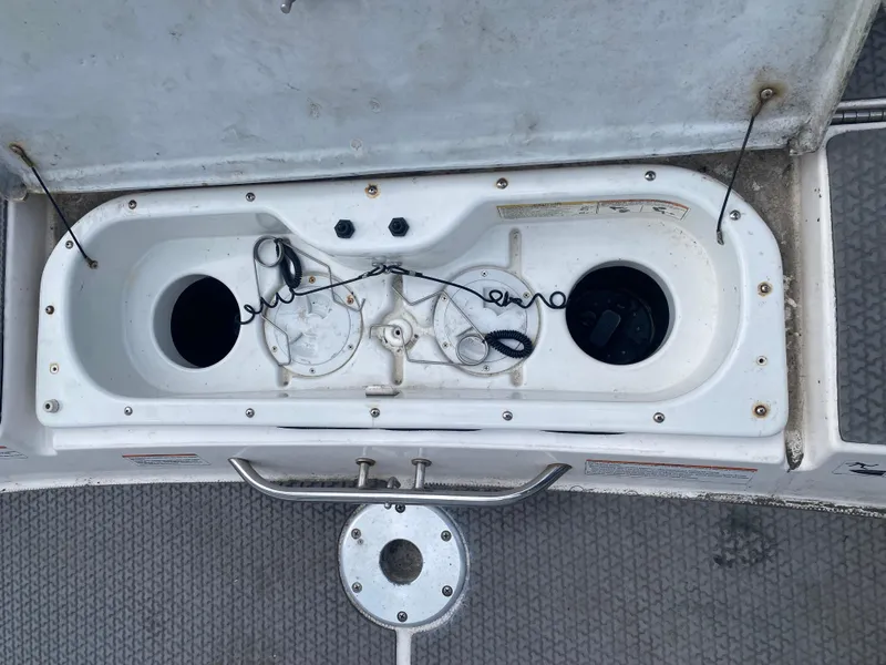 Slide: The Image of 2006 Yamaha Boats SX230 HO storage compartment with open lid and wiring visible. - 7