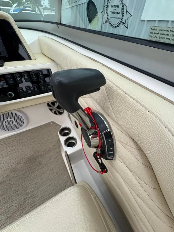 Slide: The Image of Interior of 2018 Regal 26 FasDeck boat showing control panel and throttle lever. - 10