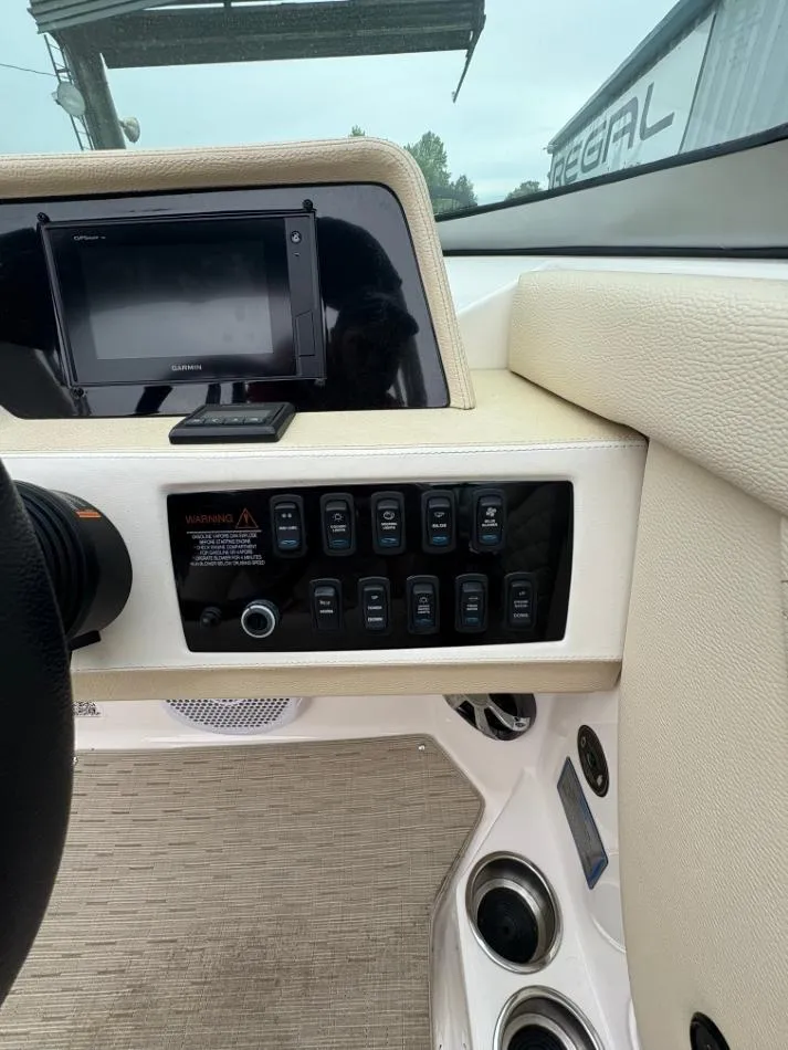 Slide: The Image of Dashboard of a 2018 Regal 26 FasDeck boat with control panel and Garmin display. - 11