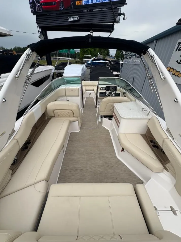 Slide: The Image of 2018 Regal 26 FasDeck boat interior with beige seating and modern dashboard. - 15