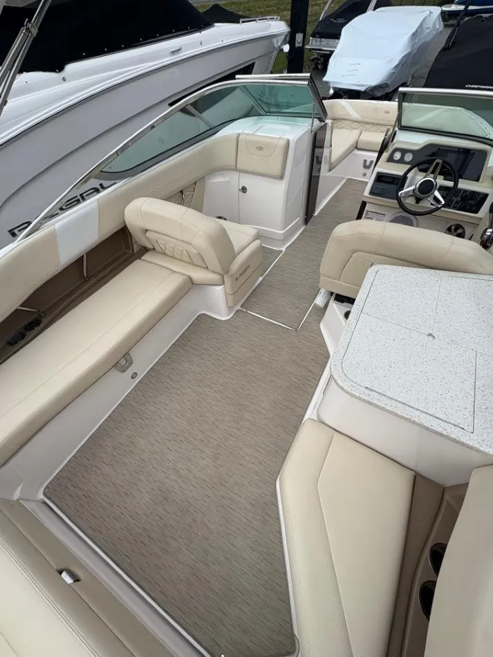 Slide: The Image of 2018 Regal 26 FasDeck boat interior with beige seating and modern dashboard. - 16