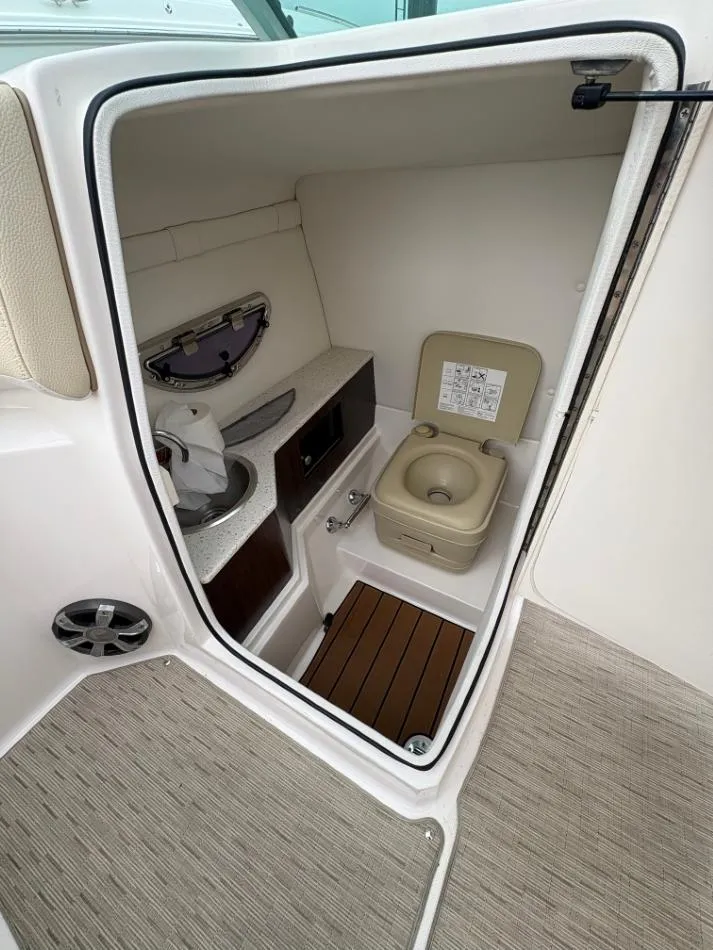 Slide: The Image of 2018 Regal 26 FasDeck boat interior with compact bathroom and toilet. - 18