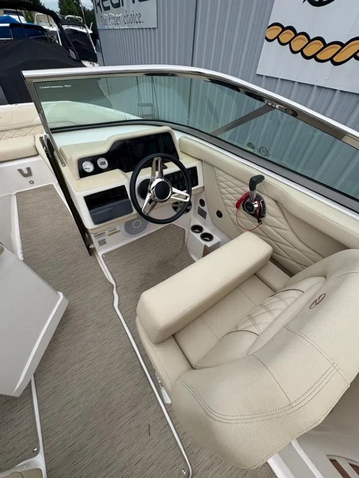 Slide: The Image of 2018 Regal 26 FasDeck boat interior with beige seating and modern dashboard. - 19
