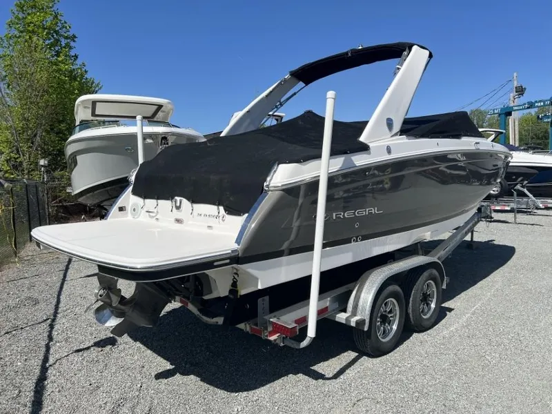Slide: The Image of 2018 Regal 26 FasDeck boat on trailer, covered and parked outdoors. - 9