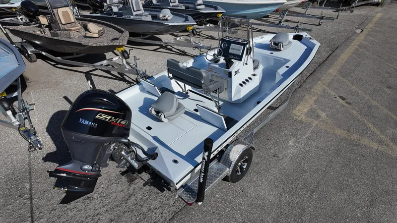 Slide: The Image of 2025 Xpress H20B boat with Yamaha engine on trailer, parked in a lot. - 21