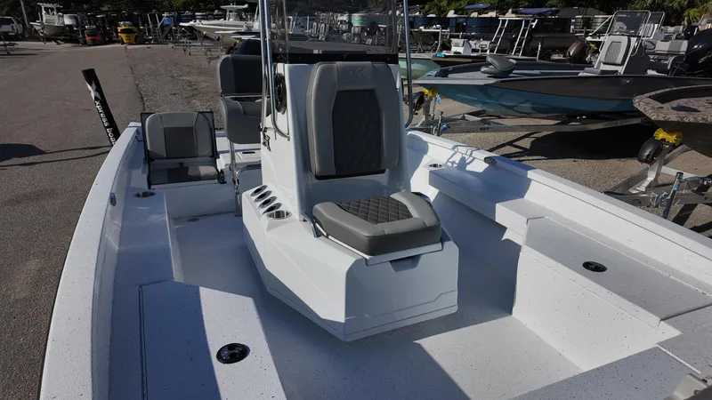 Slide: The Image of 2025 Xpress H20B boat with center console and seating, docked in a marina. - 27