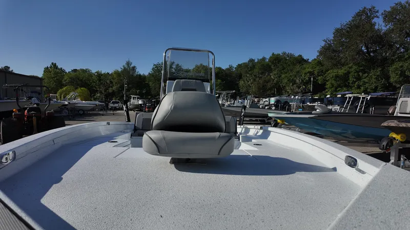 Slide: The Image of 2025 Xpress H20B boat with seating, docked outdoors under clear blue sky. - 28