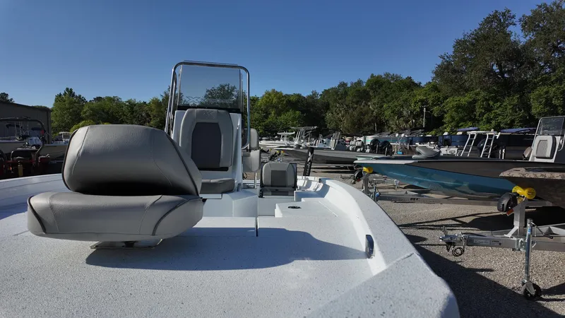 Slide: The Image of 2025 Xpress H20B boat on display in a sunny outdoor showroom. - 29