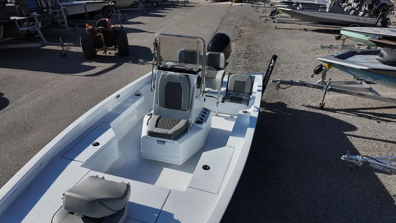 Slide: The Image of 2025 Xpress H20B boat with sleek design, parked on a trailer in a marina. - 30