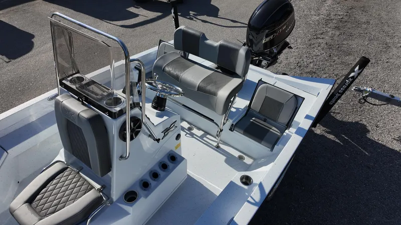 Slide: The Image of 2025 Xpress H20B boat interior with seating and steering console. - 32