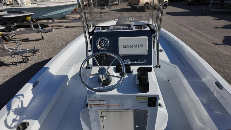 Slide: The Image of 2025 Xpress H20B boat with Garmin navigation system, steering wheel, and control panel. - 34