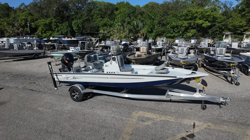Slide: The Image of 2025 Xpress H20B boat on trailer in outdoor dealership lot. - 8