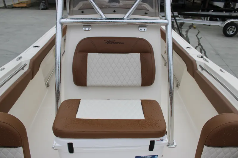 Slide: The Image of 2025 Pioneer 222 Sportfish boat interior with brown and white cushioned seating. - 12