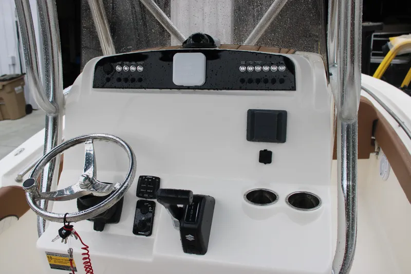 Slide: The Image of 2025 Pioneer 222 Sportfish boat console with steering wheel and controls. - 13