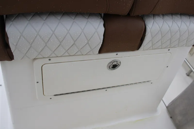 Slide: The Image of 2025 Pioneer 222 Sportfish boat seat with storage compartment and diamond-patterned upholstery. - 14