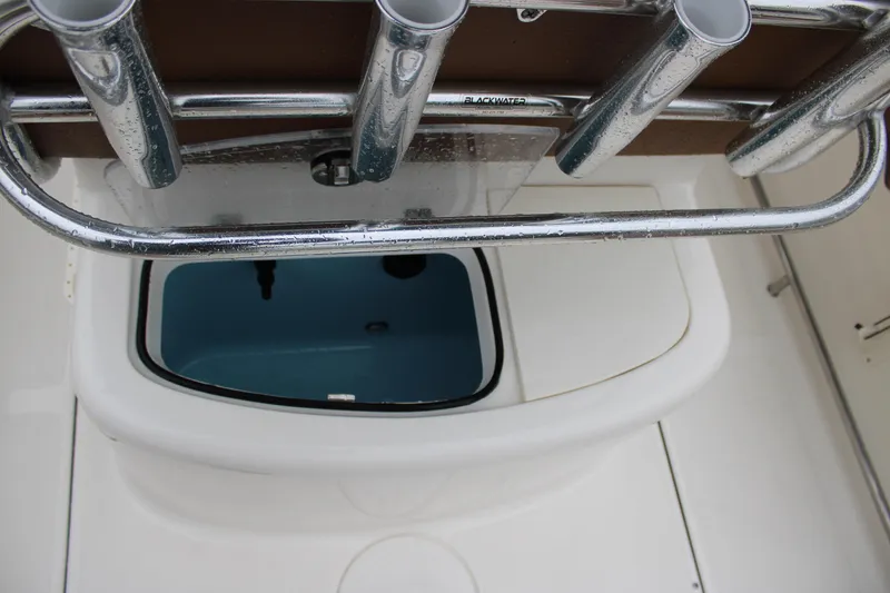 Slide: The Image of 2025 Pioneer 222 Sportfish boat with rod holders and storage compartment. - 19