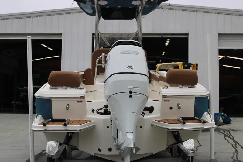 Slide: The Image of 2025 Pioneer 222 Sportfish boat with powerful outboard motor, docked at a marina. - 3