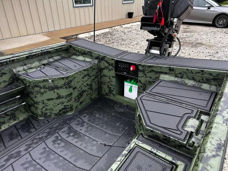 Slide: The Image of 2025 Gator Tail 1750 MID DECK SAVAGE boat interior with camouflage design and storage compartments. - 11