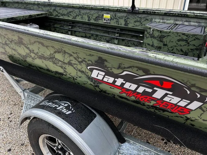 Slide: The Image of 2025 Gator Tail 1750 MID DECK SAVAGE boat with camouflage design on trailer. - 16