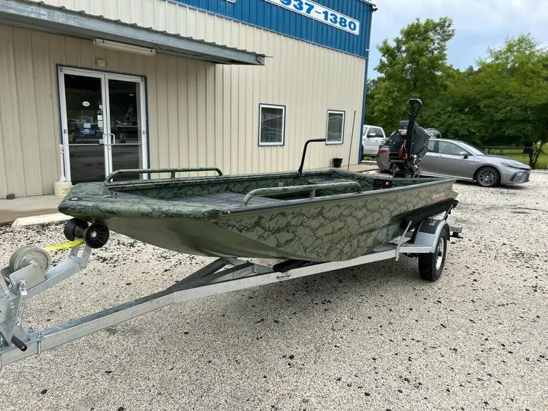 Slide: The Image of 2025 Gator Tail 1750 MID DECK SAVAGE boat on trailer, parked outside a building. - 2