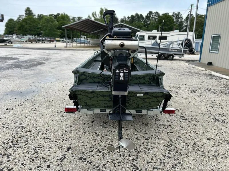 Slide: The Image of 2025 Gator Tail 1750 MID DECK SAVAGE boat, rear view, parked on gravel. - 6