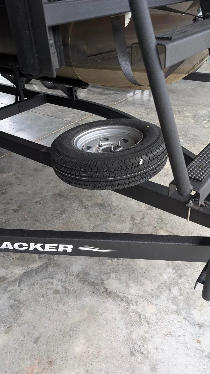 Slide: The Image of 2023 Sun Tracker Party Barge 20 DLX trailer with spare tire on concrete floor. - 14