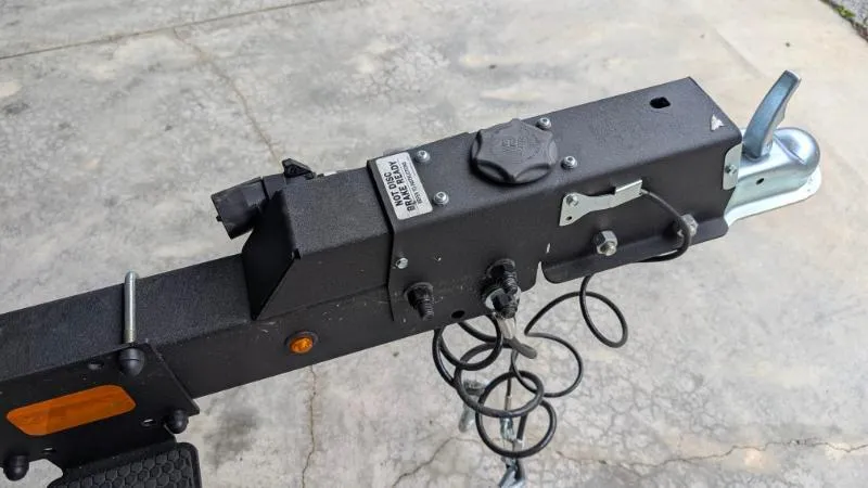 Slide: The Image of Trailer hitch of 2023 Sun Tracker Party Barge 20 DLX on concrete surface. - 15