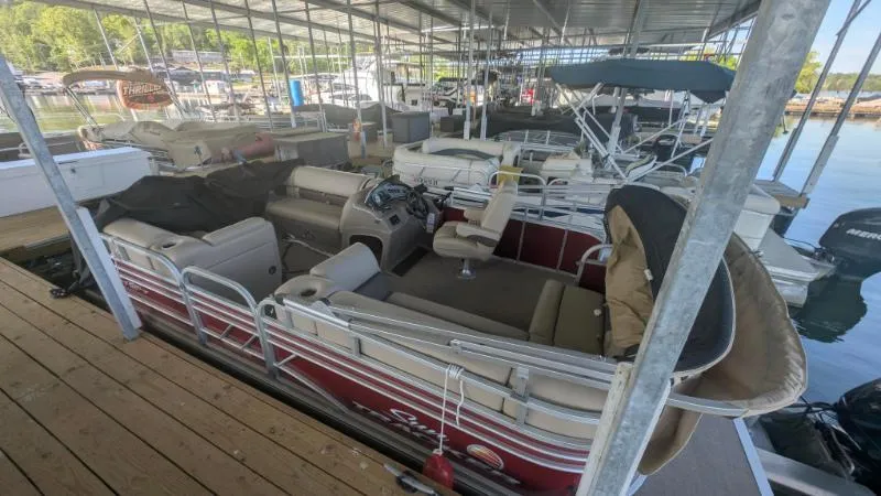 Slide: The Image of 2023 Sun Tracker Party Barge 20 DLX pontoon boat docked in a marina. - 17