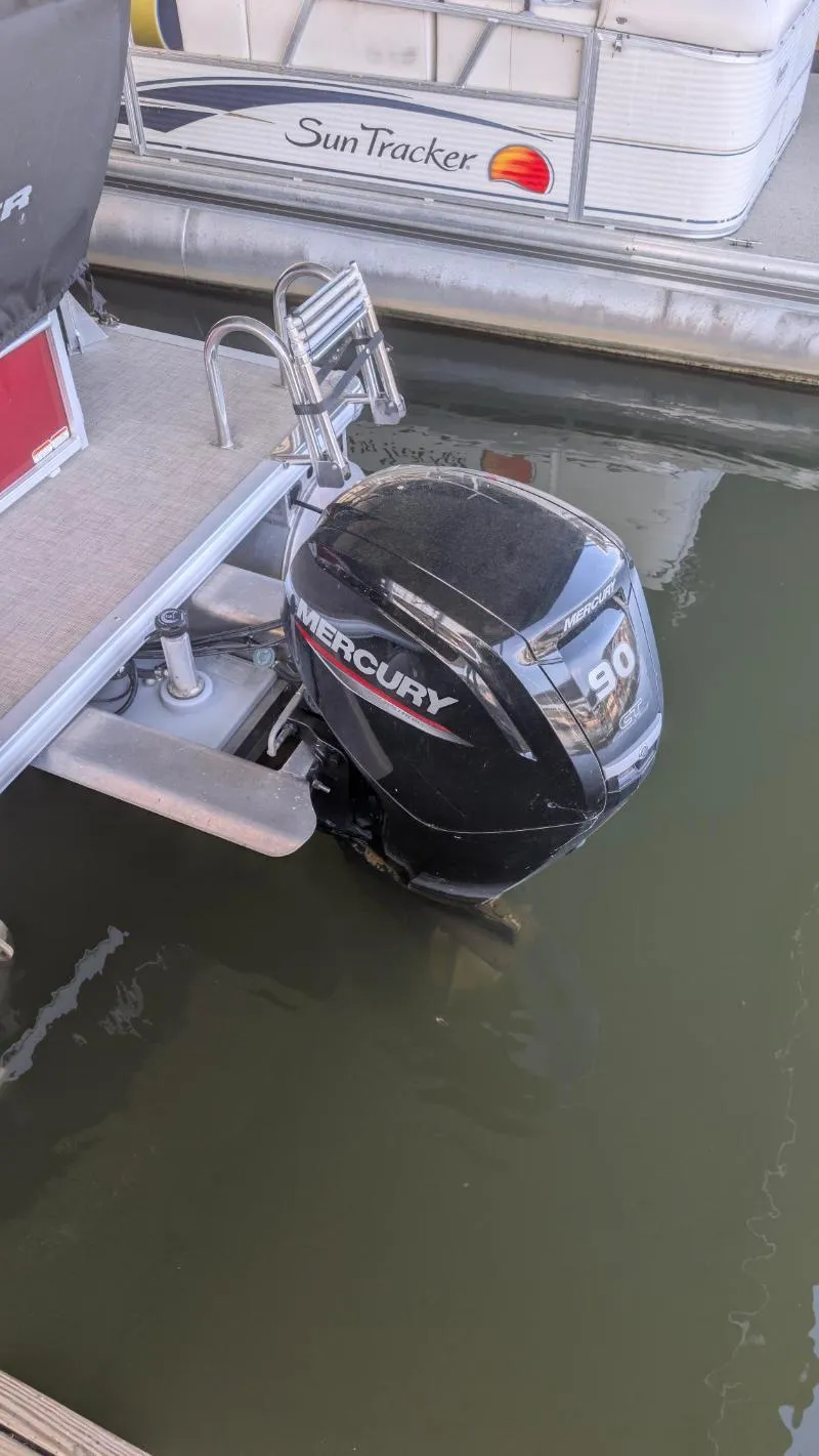 Slide: The Image of 2023 Sun Tracker Party Barge 20 DLX with Mercury 90 outboard motor in water. - 18