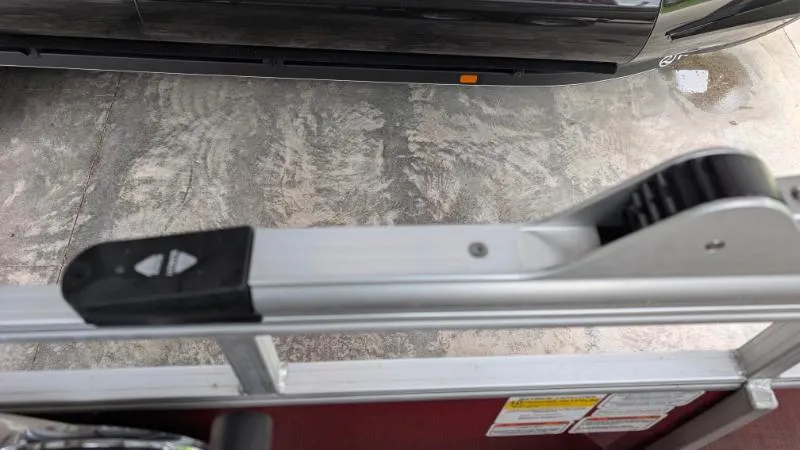 Slide: The Image of Close-up of a 2023 Sun Tracker Party Barge 20 DLX railing and latch mechanism. - 20