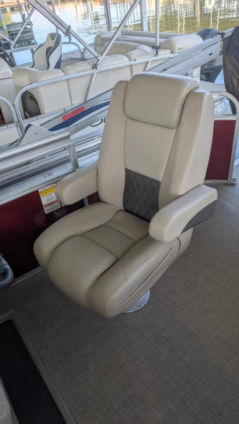 Slide: The Image of 2023 Sun Tracker Party Barge 20 DLX captain's chair, beige with armrests, on a pontoon boat. - 23