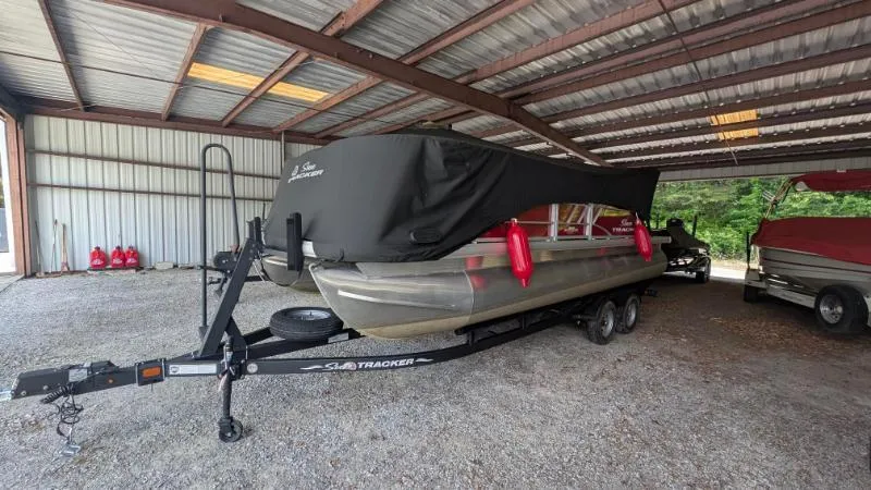 Slide: The Image of 2023 Sun Tracker Party Barge 20 DLX pontoon boat under a metal shelter. - 26