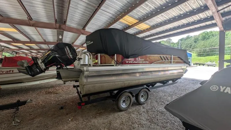 Slide: The Image of 2023 Sun Tracker Party Barge 20 DLX pontoon boat under a metal shelter. - 28