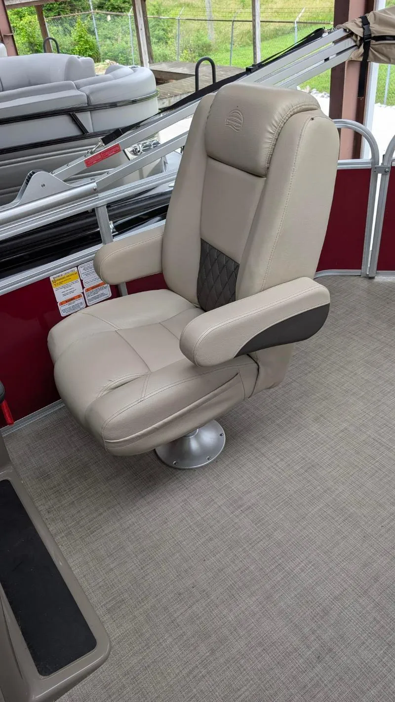 Slide: The Image of 2023 Sun Tracker Party Barge 20 DLX captain's chair, beige upholstery, on a pontoon boat. - 8